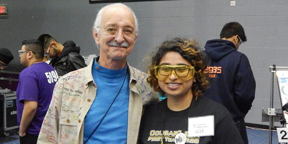 A picture with a past student and Woodie Flowers.